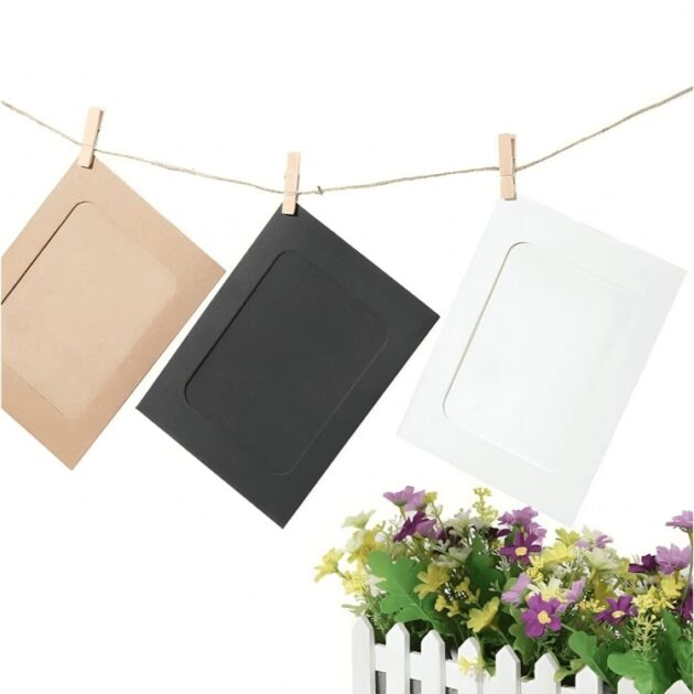 Paper photo frames with clips hanging on a string in black, white, and brown colors, ideal for home or event decor.