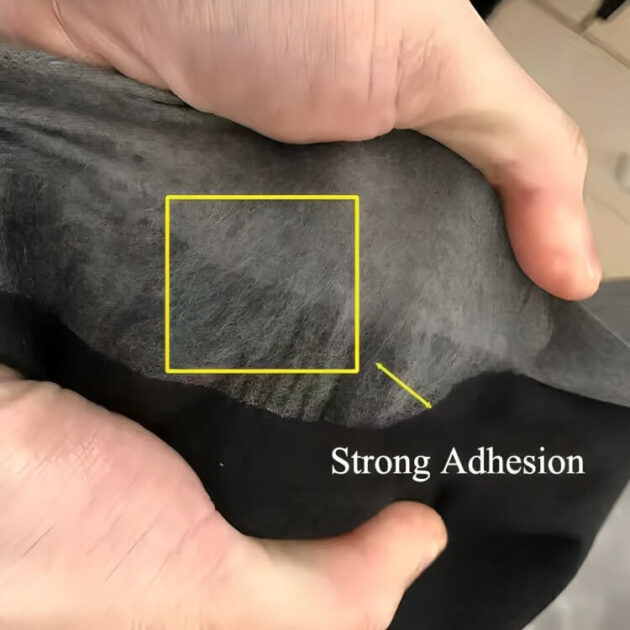 A person holds pants hemmed with iron-on tape, highlighting the strong adhesion and neat finish.