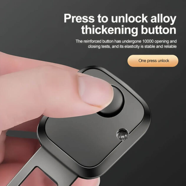 Close-up of alloy thickening button on seat belt extender being pressed.